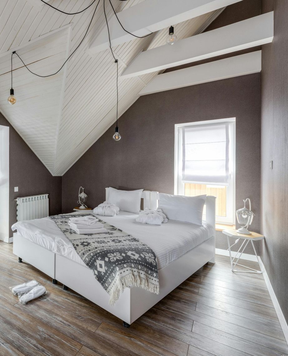A bedroom with a large bed and a window