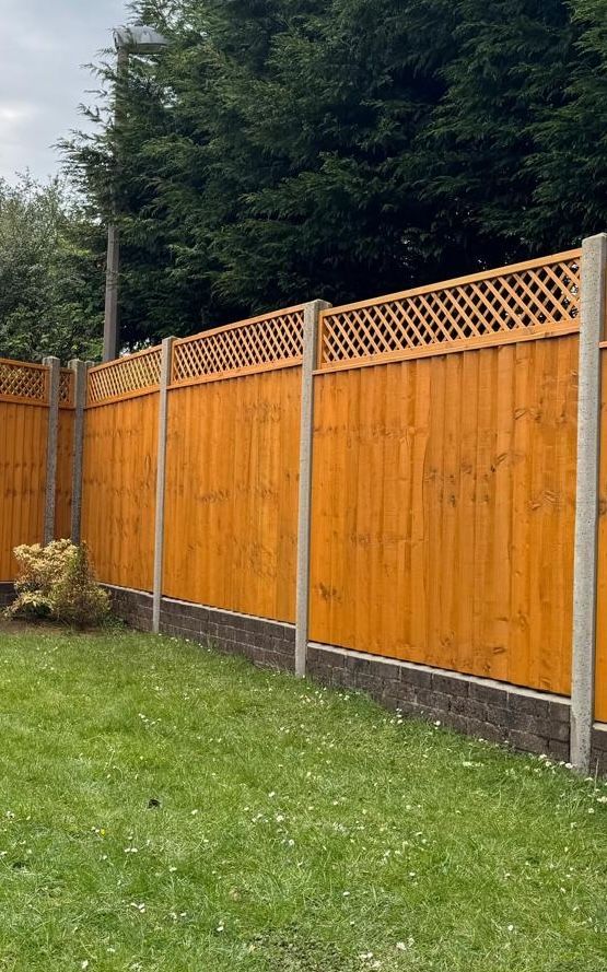 A backyard with white-grey painted fence