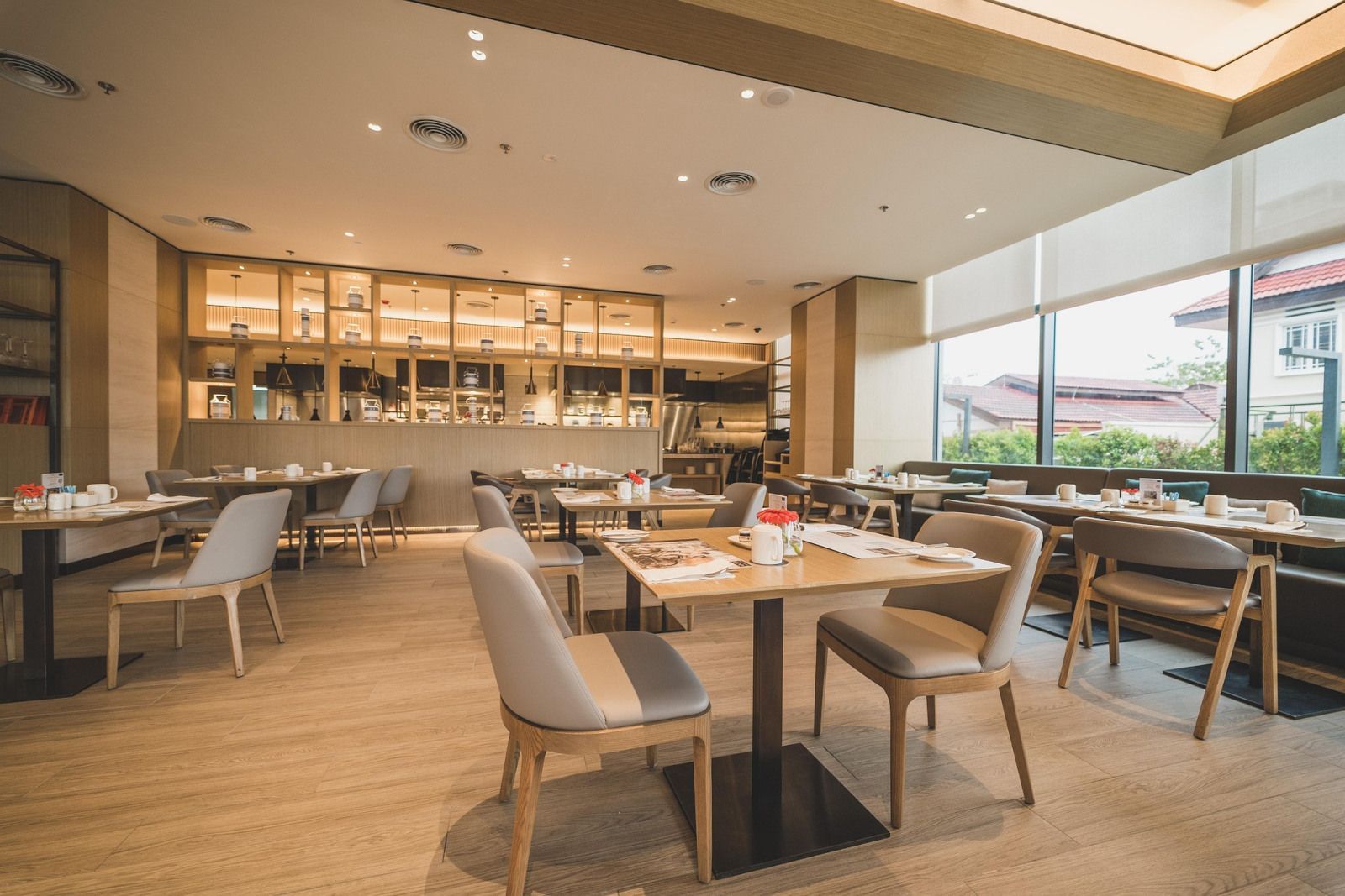 A restaurant with tables and chairs and a large window.