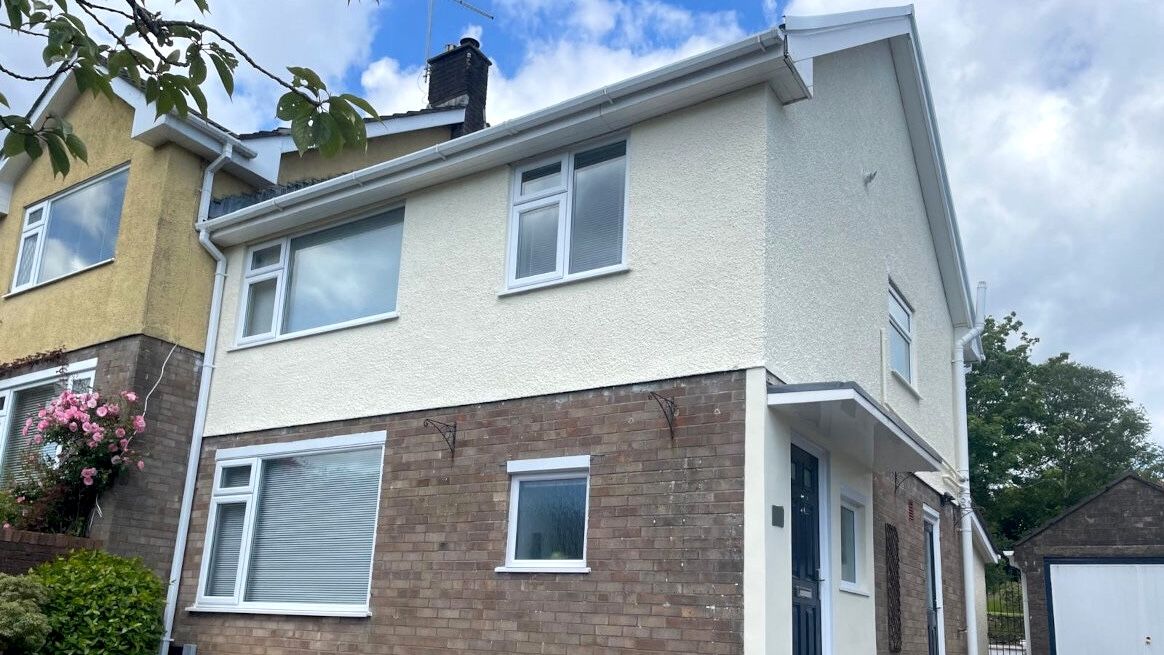 Exterior of Swansea (Mumbles) terraced house with expertly painted render pebbledash walls by Daffodil Decor.