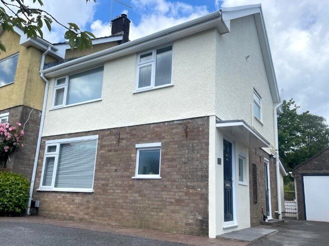 Feature wall wallpaper installation in Mumbles home dining room interior by Daffodil Decor.