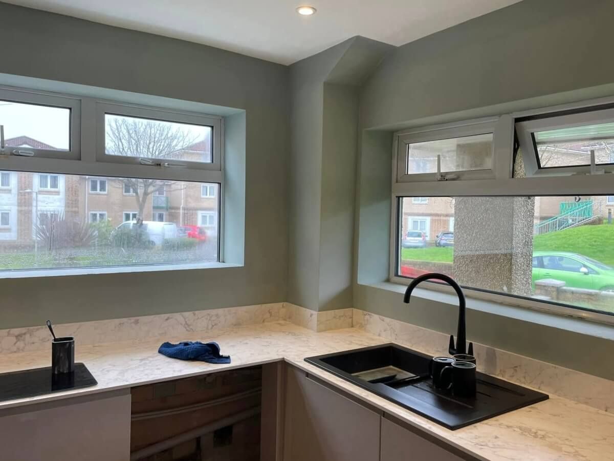 Kitchen interior painted green walls by Daffodil Decor in a Mumbles home in Swansea.