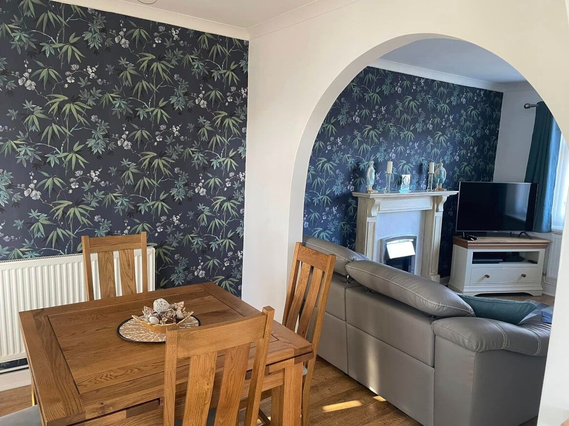 House refurbishment and redecoration by Daffodil Decor in Swansea. Dining room and living room with floral wallpaper feature wall.