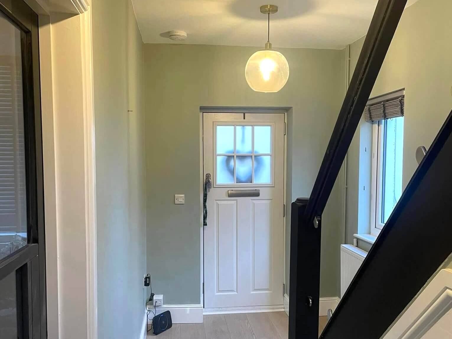 Swansea home entrance hallway with expertly painted walls, door and staircase by Daffodil Decor.