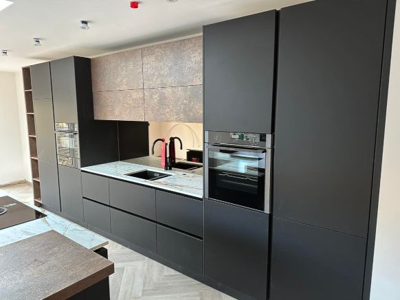 Modern dark gray kitchen with newly painted cabinets by Daffodil Decor. Swansea, Wales.