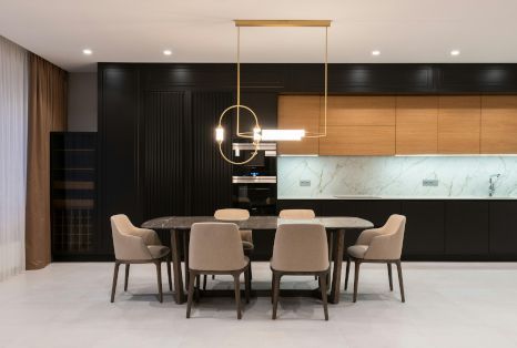 A dining room with a table and chairs in a kitchen.