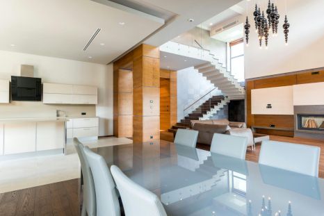 A dining room table and chairs in a modern house. Staircase expertly painted by Daffodil Decor in Swansea, Wales.