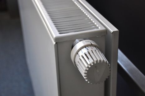 A white radiator with a white thermostat on it