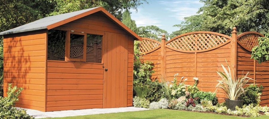 Lovely brown garden shed in a Swansea garden, expertly painted by Daffodil Decor.