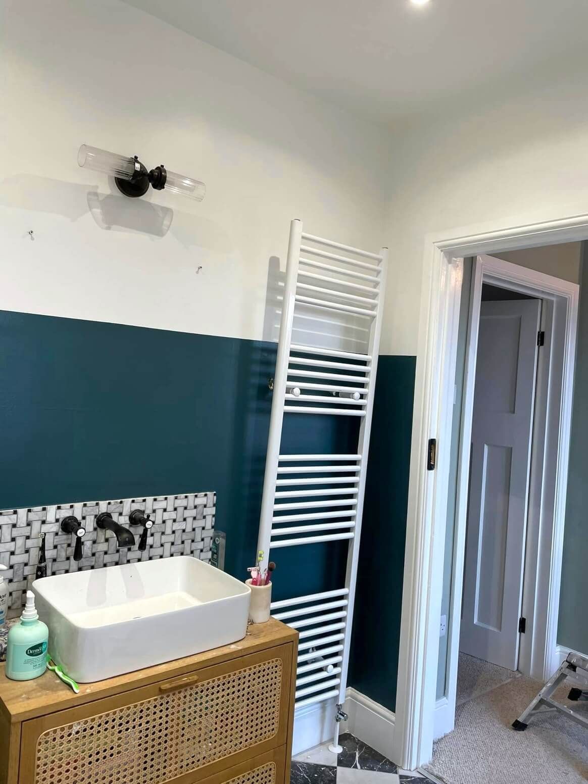 Swansea bathroom with white radiator, tile splashback, white and blue walls painted by Daffodil Decor.