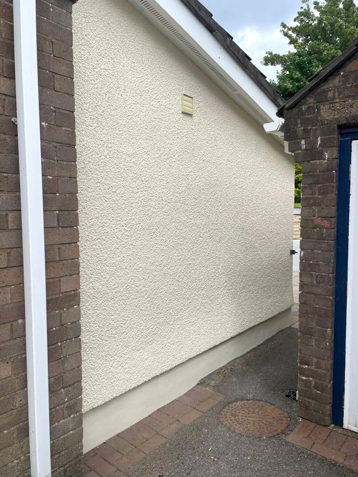 Swansea house exterior wall pebbledash render painted in cream colour by Daffodil Decor.