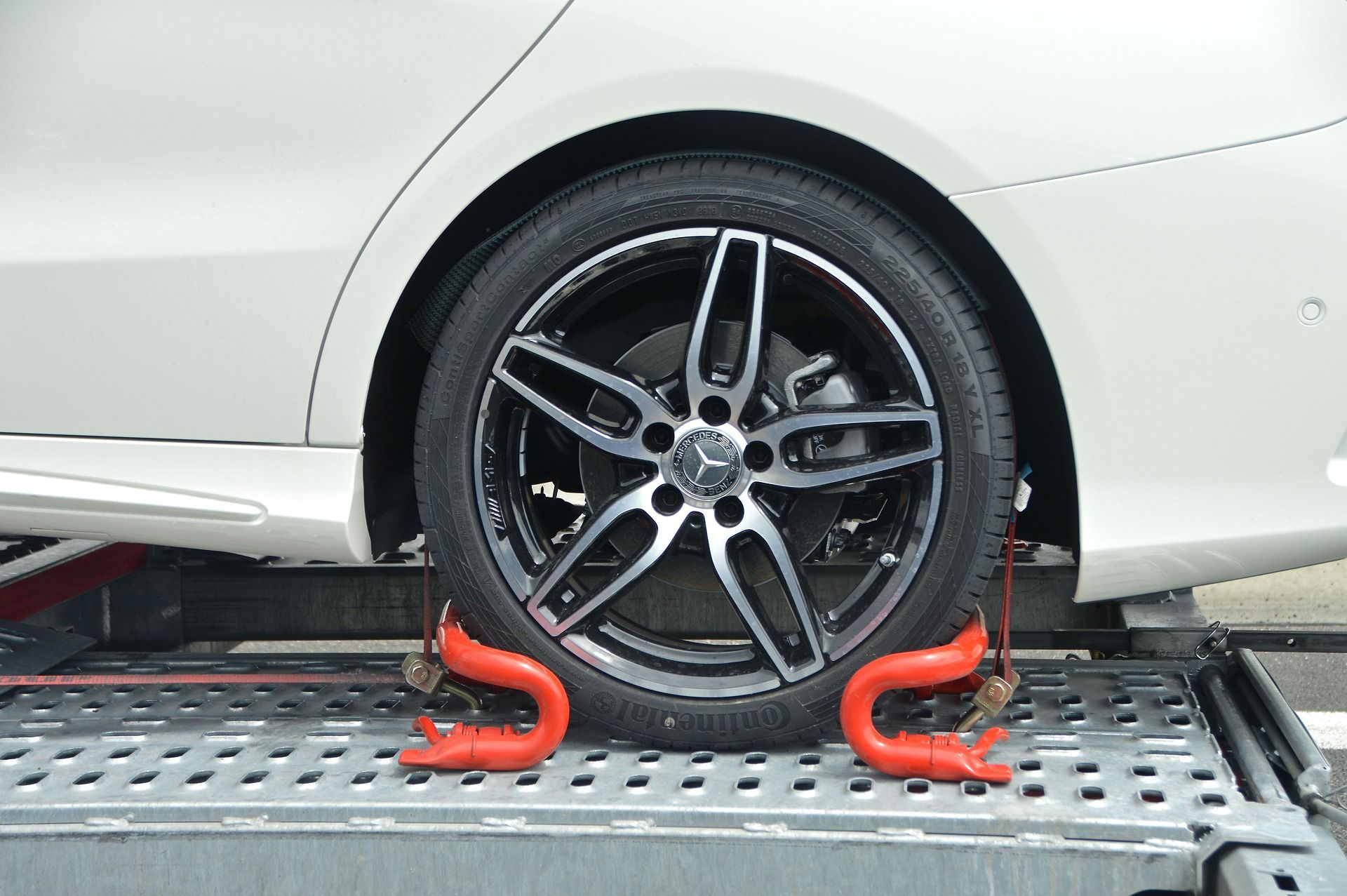 A Car Tire Secured to a Metal Transport Trailer — JP's Towing and Transport in Murphy's Creek, QLD