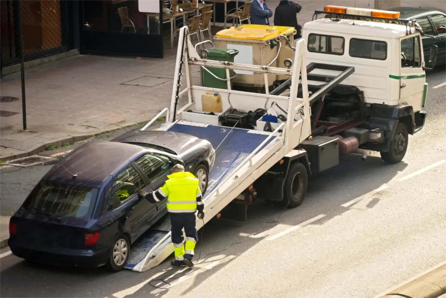 A Worker in a High-visibility Jacket Prepares to Load a Car On a Tow Truck — JP's Towing and Transport in Toowoomba City, QLD
