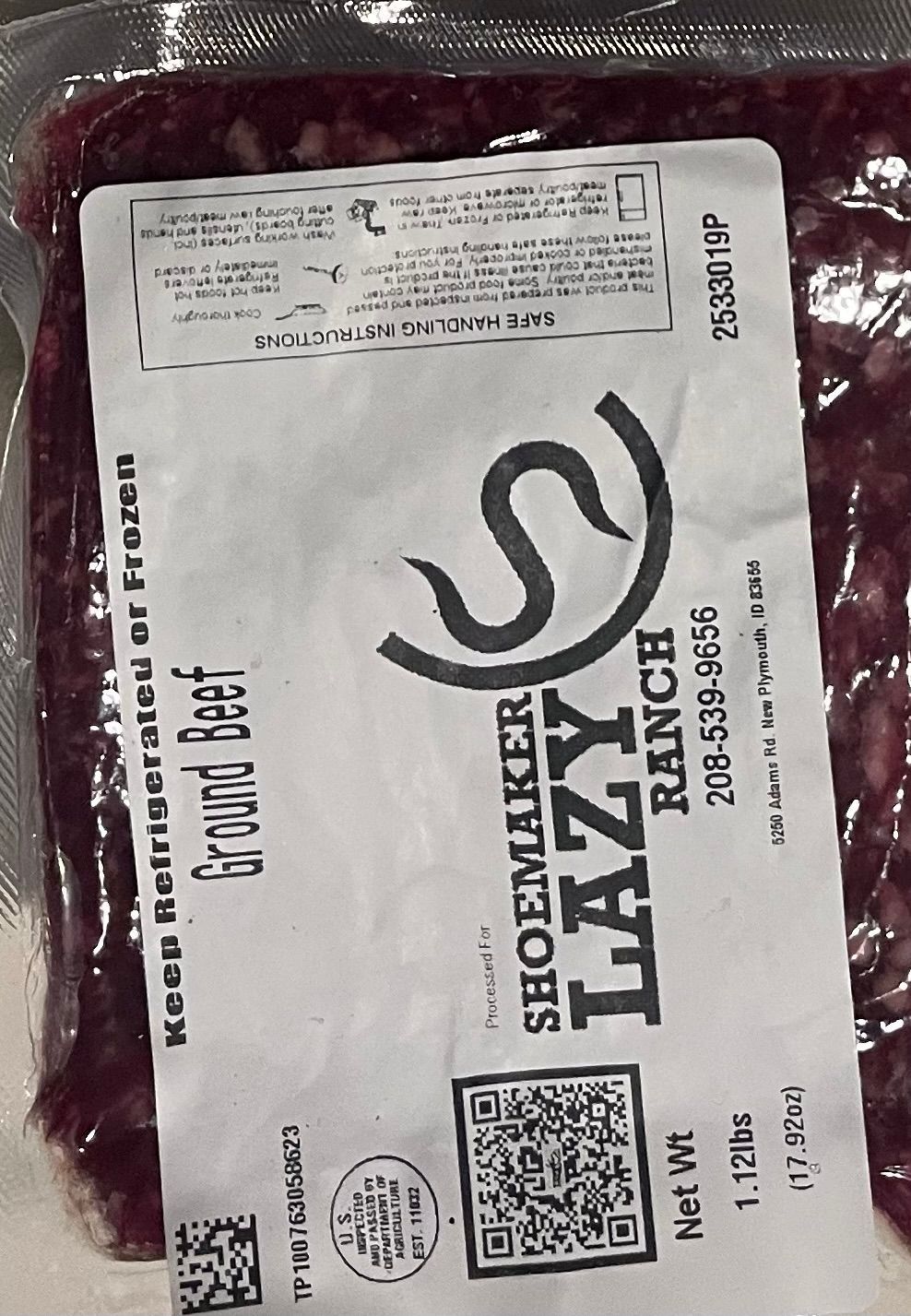 A package of ground beef is sitting on a yellow table