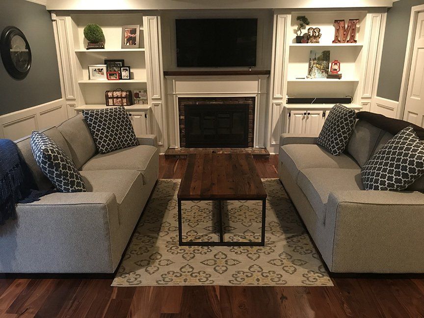 A living room with two couches and a fireplace