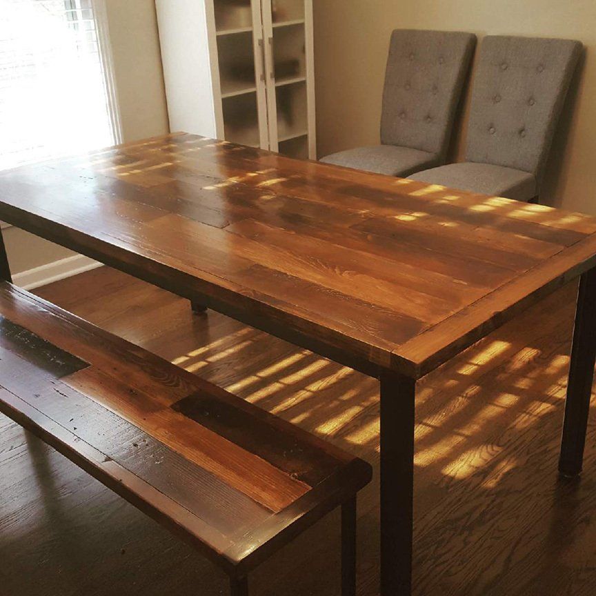A wooden table with a bench underneath it