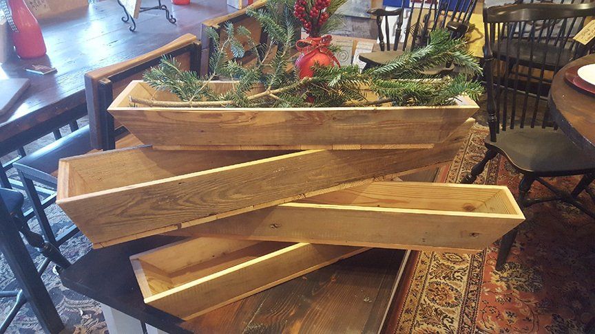 Three wooden boxes are stacked on top of each other on a table.