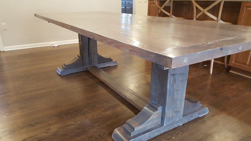 A wooden table is sitting on a wooden floor in a living room.