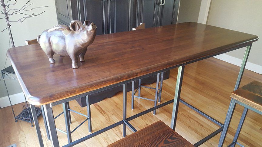 A statue of a pig is sitting on top of a wooden table.