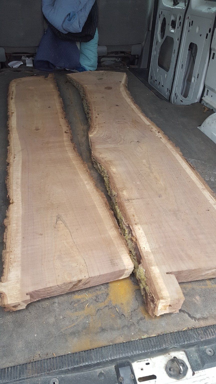 Two pieces of wood are sitting in the back of a van.