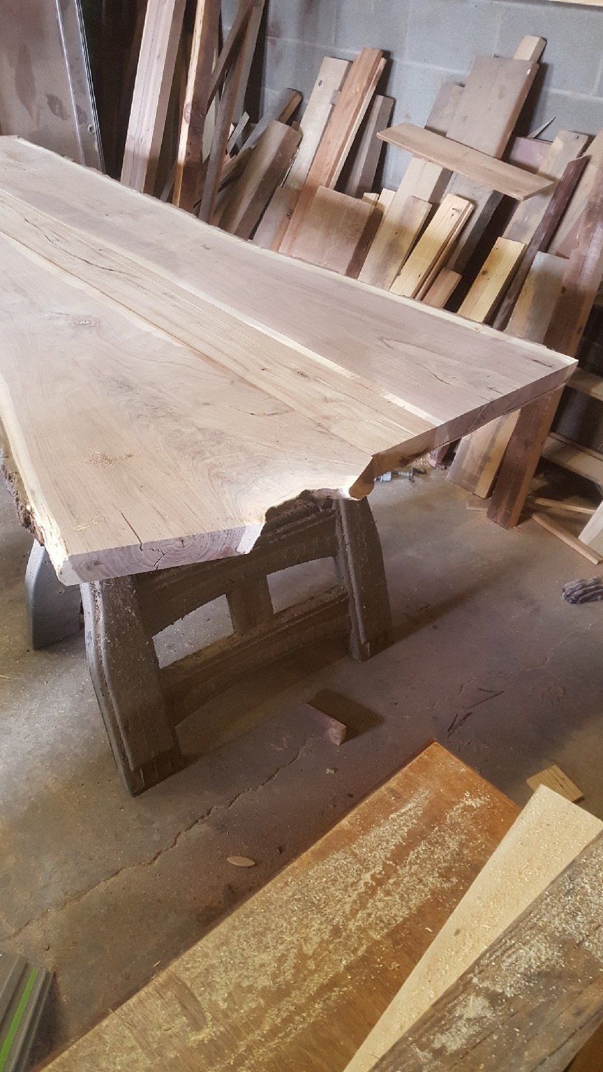 A wooden table is sitting on top of a pile of wood.