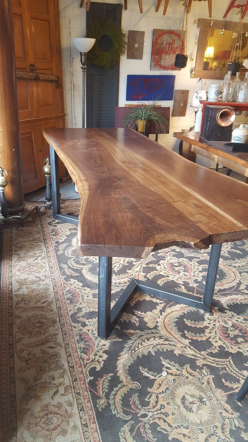 A wooden table is sitting on top of a rug in a room.