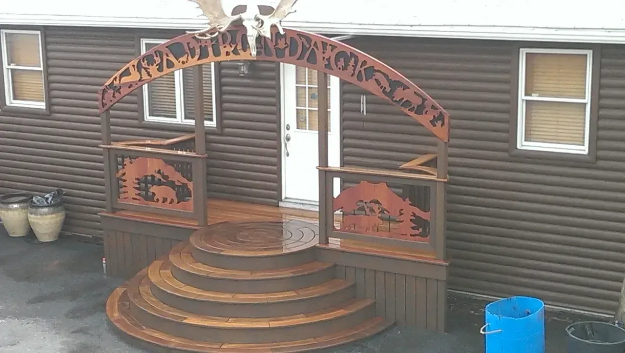Wooden entryway with steps, arch, and animal silhouettes; a white door is in the background.