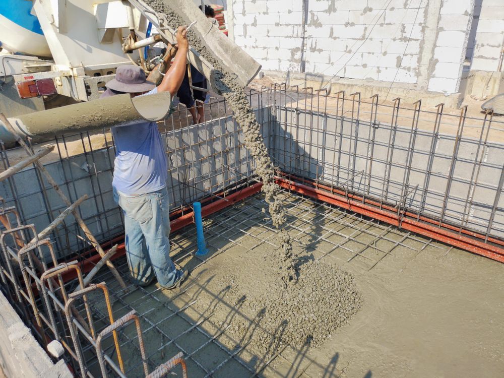 A Man is Pouring Concrete Into a Swimming Pool — Tweed Coast Concrete Pumping in Murwillumbah, NSW