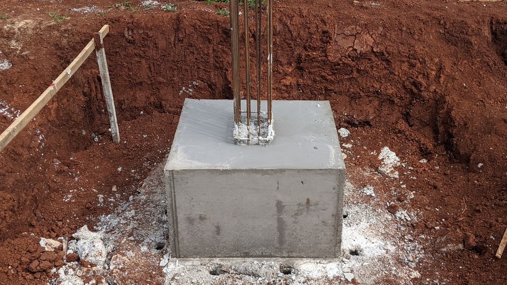 A Concrete Block is Sitting in the Middle of a Dirt Field — Tweed Coast Concrete Pumping in Murwillumbah, NSW