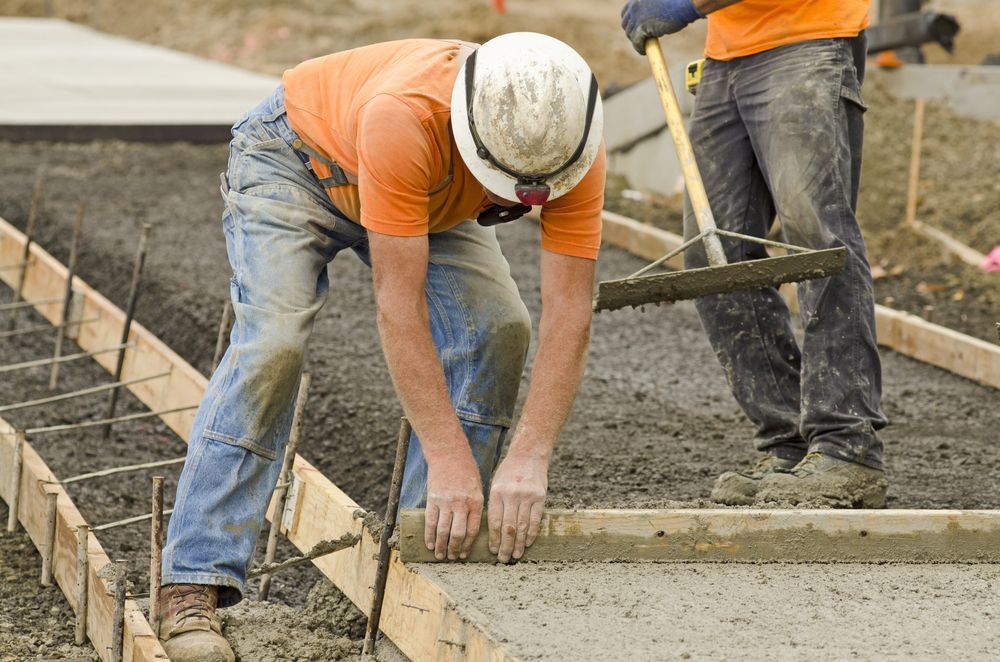Two Construction Workers Are Working on a Concrete Sidewalk — Tweed Coast Concrete Pumping in Banora Point, NSW
