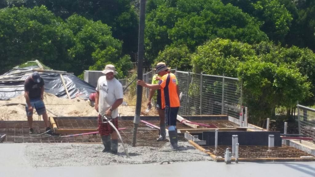A Group of Construction Workers Are Working on a Road — Tweed Coast Concrete Pumping in Chinderah, NSW