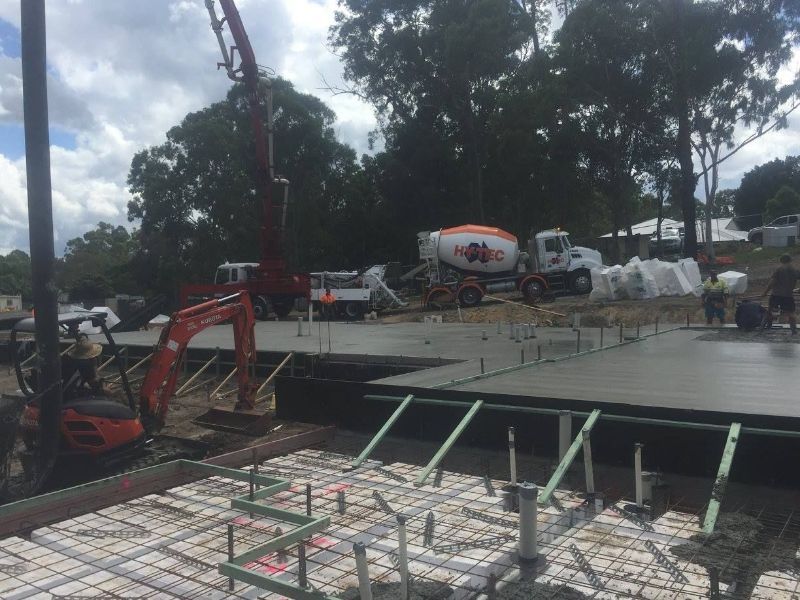 A Concrete Pump is Being Used to Pour Concrete on a Construction Site — Tweed Coast Concrete Pumping in Chinderah, NSW