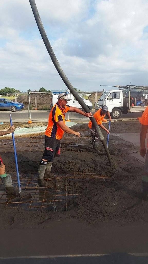 A Group of Construction Workers Are Pumping Concrete on a Construction Site — Tweed Coast Concrete Pumping in Chinderah, NSW