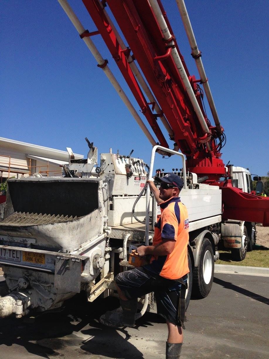 A Man is Working on a Concrete Pump Truck — Tweed Coast Concrete Pumping in Chinderah, NSW
