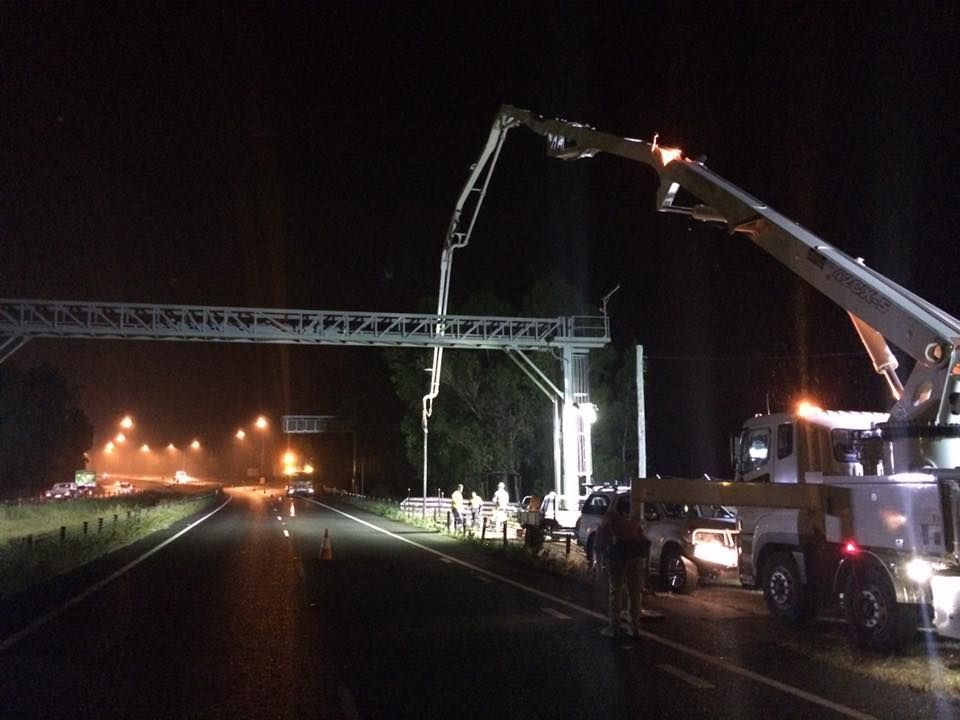 A Bridge is Being Built on the Side of a Highway at Night — Tweed Coast Concrete Pumping in Chinderah, NSW