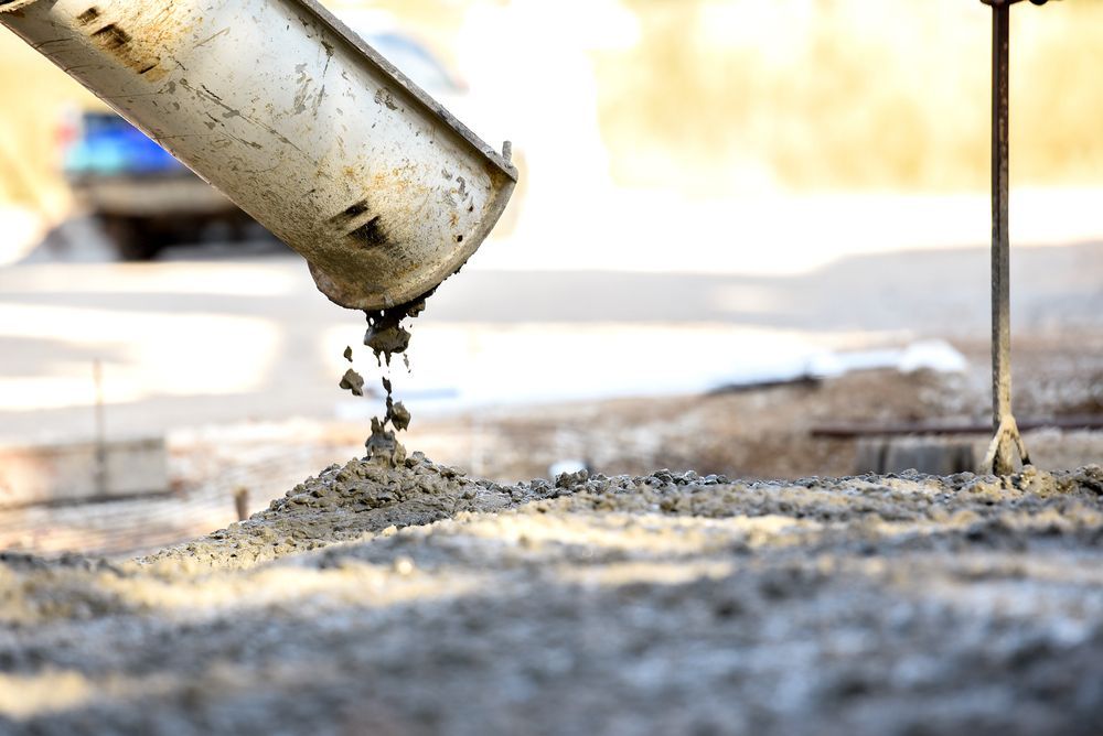 A Concrete Pump is Pouring Concrete Into the Ground — Tweed Coast Concrete Pumping in Gold Coast, QLD