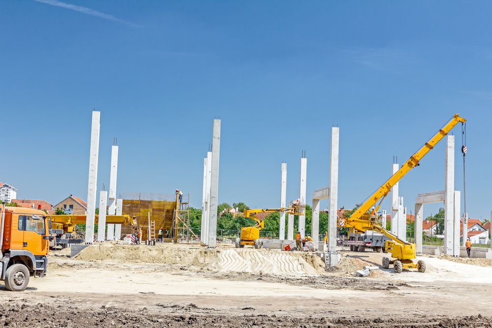 A Construction Site With a Lot of Machinery and a Truck — Tweed Coast Concrete Pumping in Chinderah, NSW