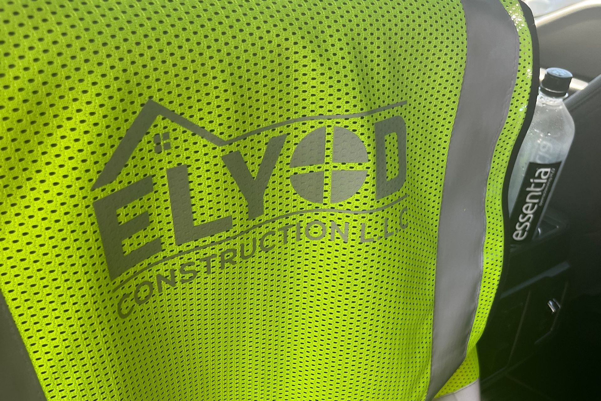 Elyod Construction business logo on yellow work vest 