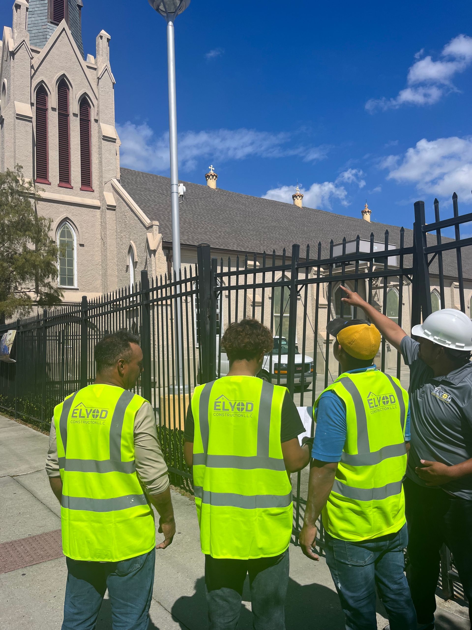 Elyod Construction contractors on site looking at church building