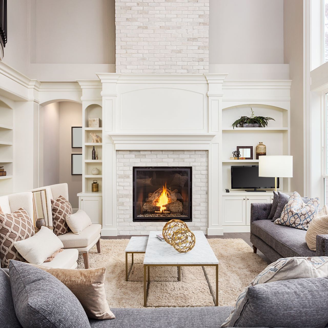 beautiful living room with brick fireplace after professional home renovation