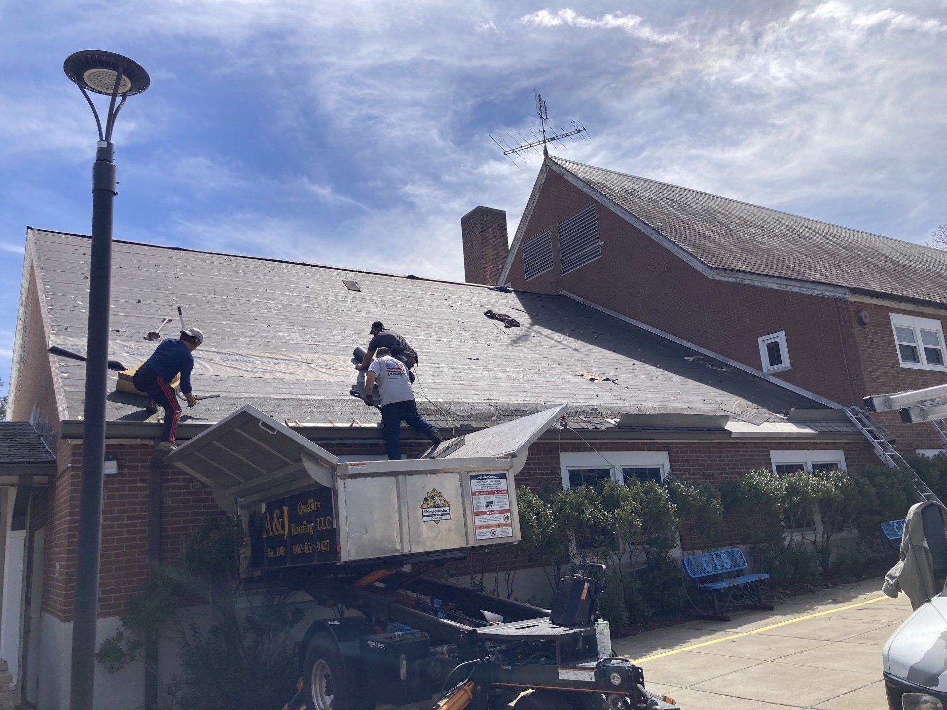 Three Men Working on Roof with Lifter — New Hartford, CT — A & J Quality Roofing LLC