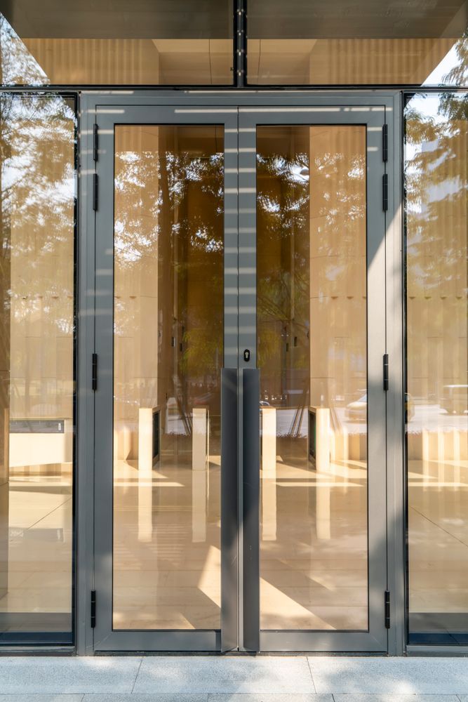 Modern Glass Double Doors With Metal Frames on a House — ALUBEST Windows & Doors In Southport, QLD