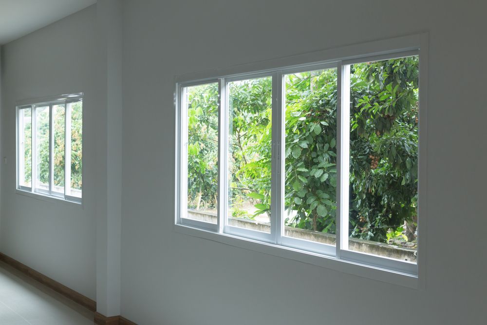 Bright Empty Room With White Walls and Large Windows — ALUBEST Windows & Doors In Southport, QLD
