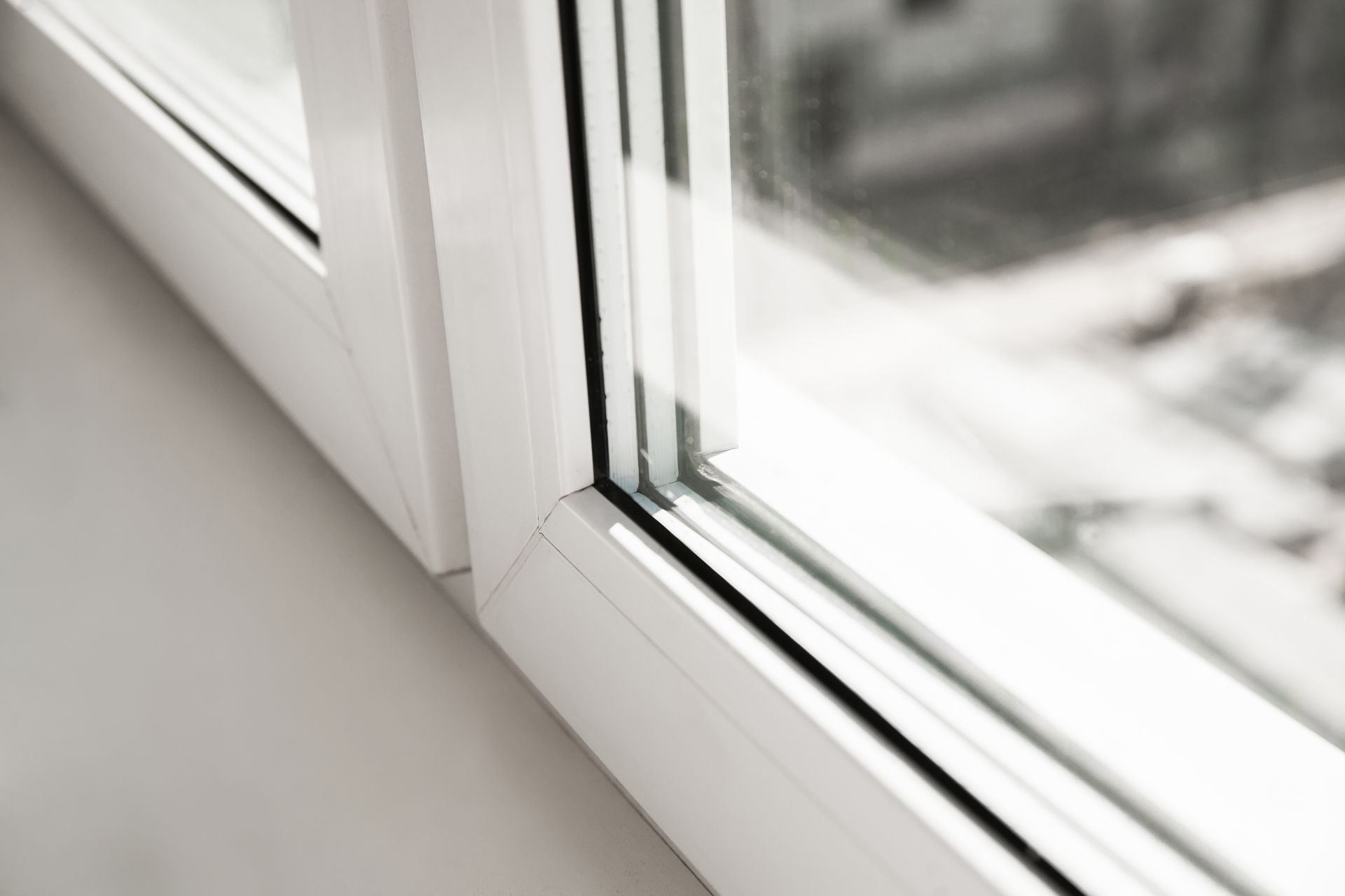 Close-up of a White Window Frame and Glass Corner — ALUBEST Windows & Doors In Southport, QLD