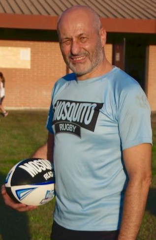Un uomo con la barba indossa una giacca nera con la scritta vxr