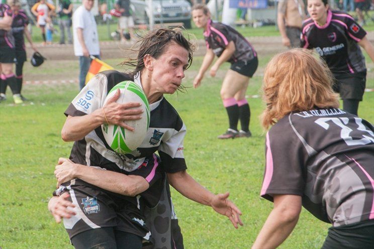 Un gruppo di donne sta giocando a rugby su un campo.