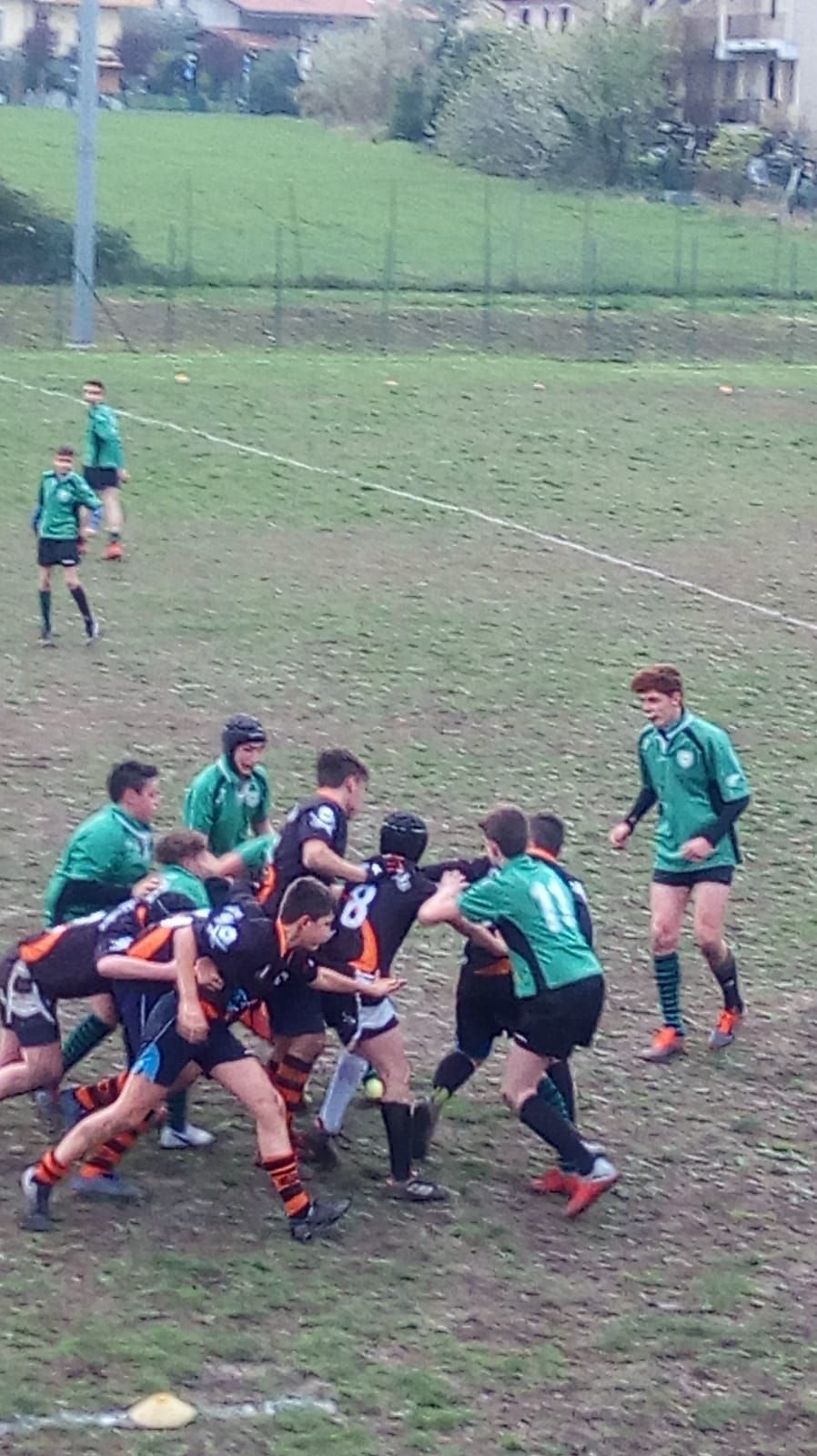 Un gruppo di giovani uomini sta giocando a rugby su un campo.