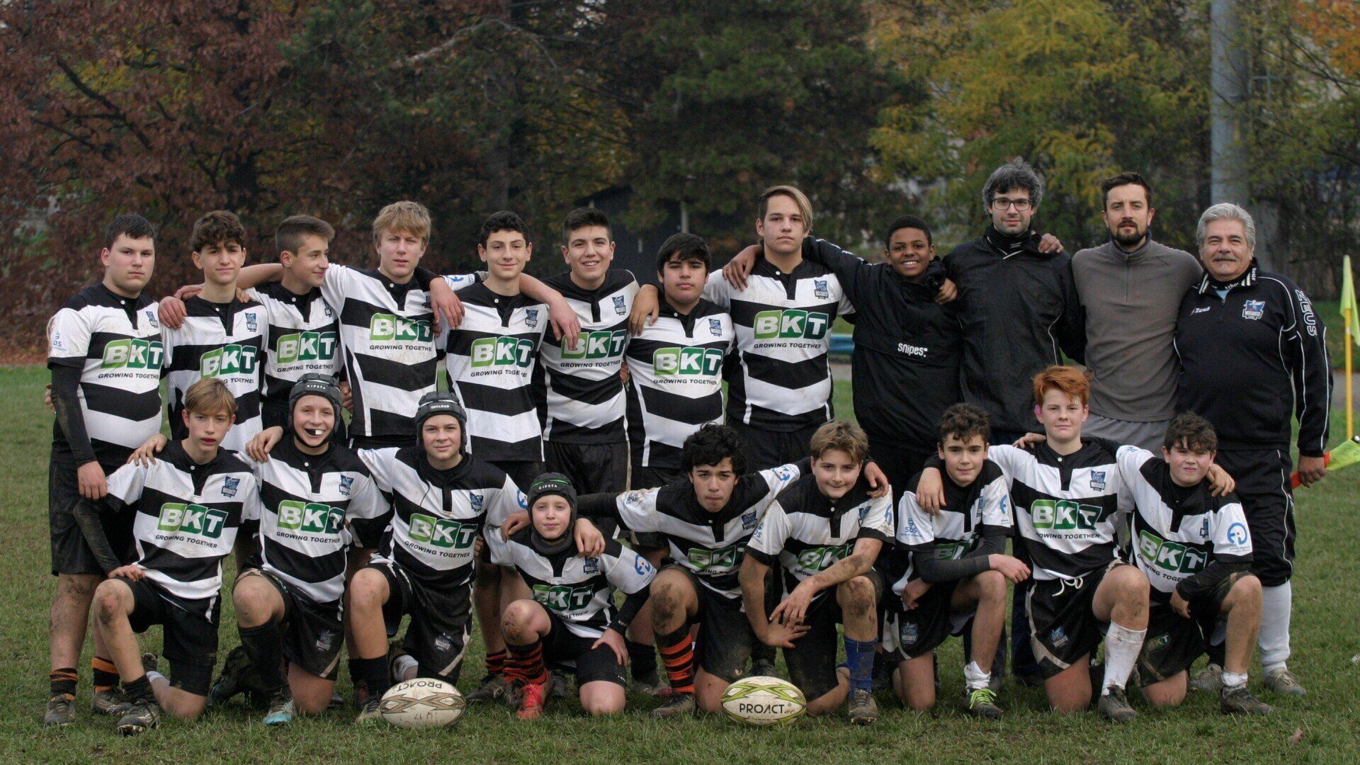 Un gruppo di ragazzi posa per una foto in un campo.