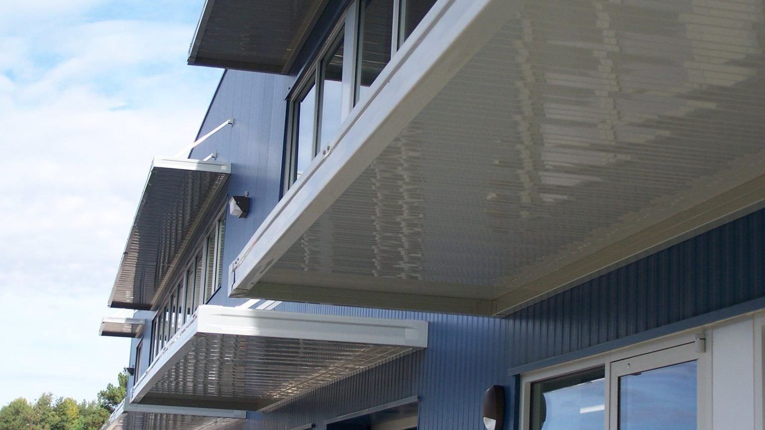 White aluminum rod canopy awning with roll formed gutter