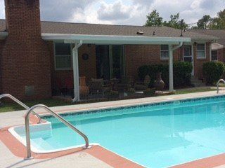 Post supported awning by pool